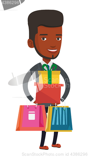 Image of Happy man holding shopping bags and gift boxes.