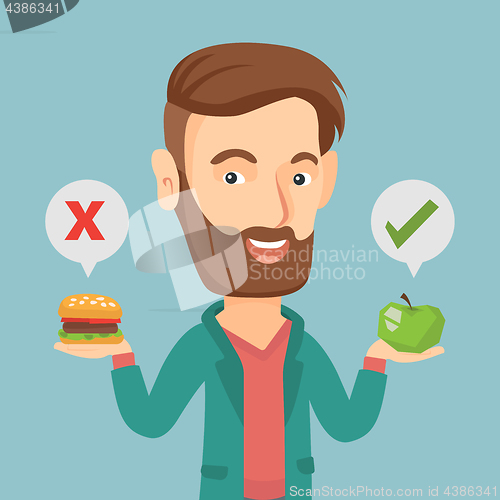 Image of Man choosing between hamburger and cupcake.