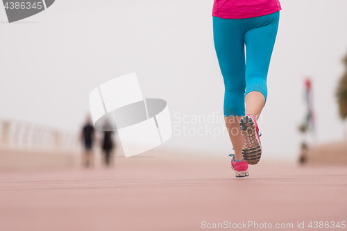 Image of woman busy running on the promenade