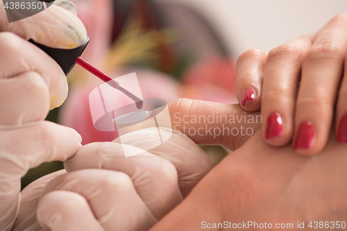 Image of Woman hands receiving a manicure