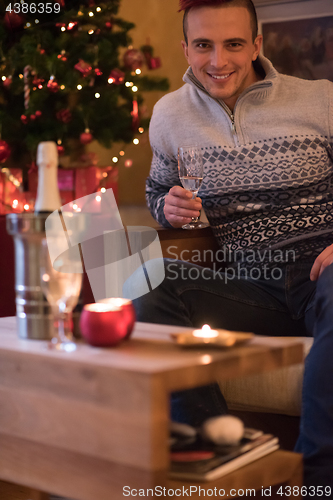 Image of Happy young man with a glass of champagne