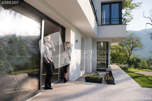 Image of couple enjoying on the door of their luxury home villa