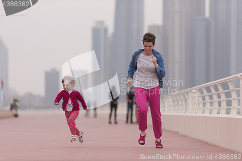 Image of mother and cute little girl on the promenade