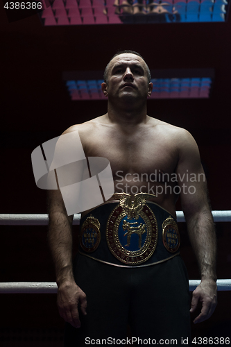 Image of kick boxer with his championship belt