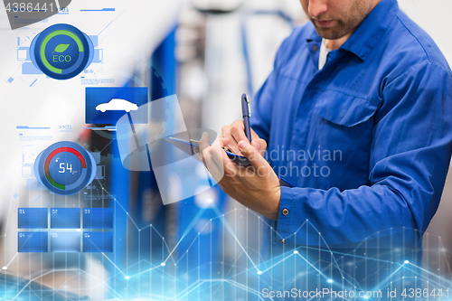 Image of auto mechanic with clipboard at car repair shop