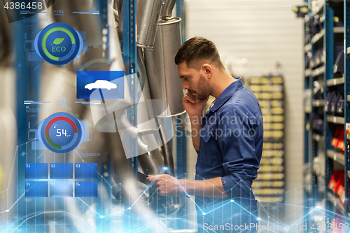 Image of auto mechanic with clipboard at car workshop