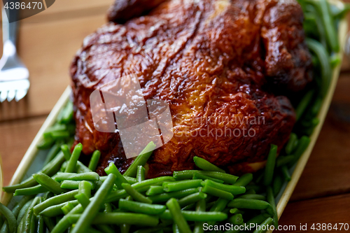 Image of close up of roast chicken with green beans