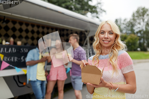 Image of happy woman with wok and friends at food truck