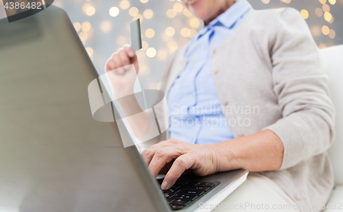 Image of senior woman with laptop and credit card