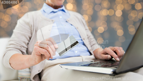 Image of senior woman with laptop and credit card