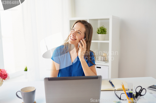 Image of woman calling on smartphone at office or home