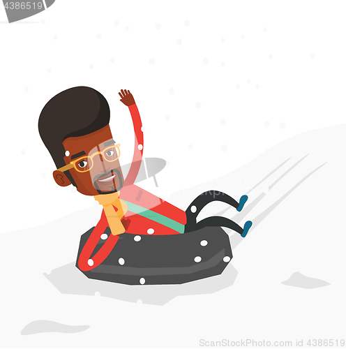 Image of Man sledding on snow rubber tube in mountains.