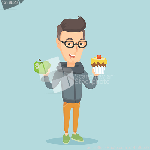 Image of Man choosing between apple and cupcake.