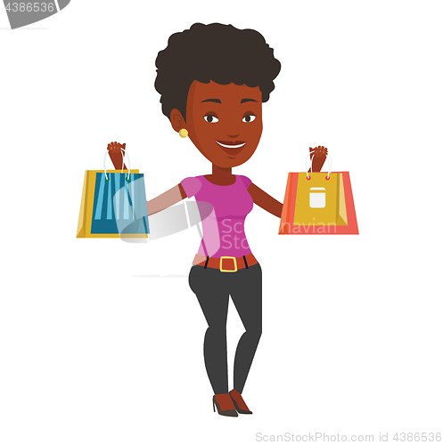 Image of Happy woman holding shopping bags.