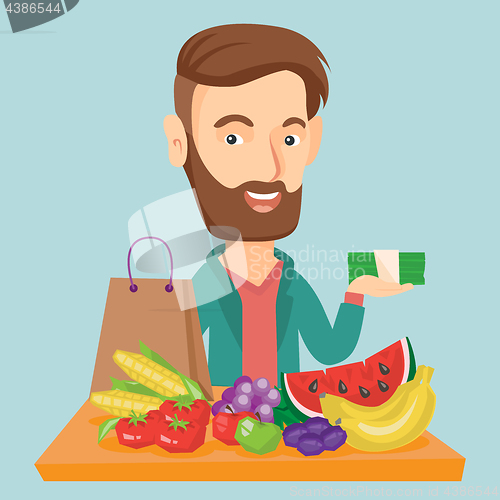 Image of Man standing at the table with shopping bag.
