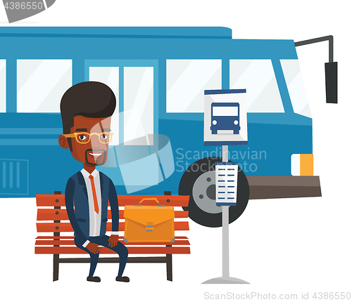 Image of Business man waiting at the bus stop.