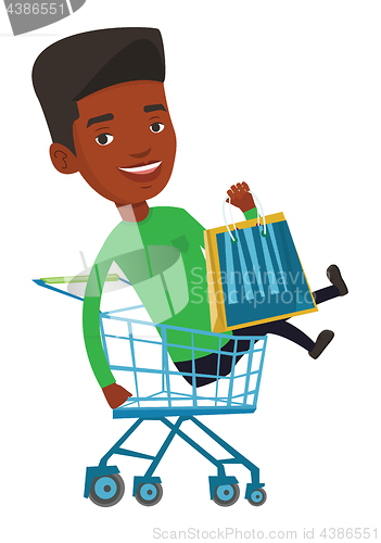 Image of Happy man riding by shopping trolley.