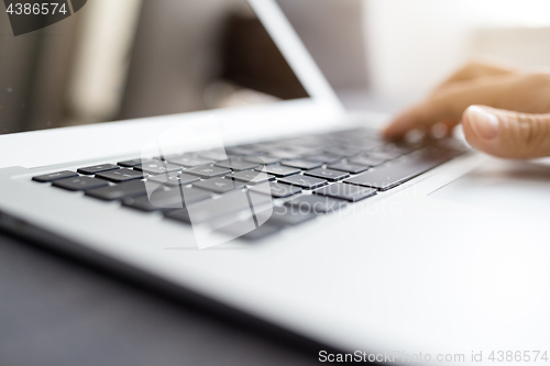 Image of Human hands working on laptop