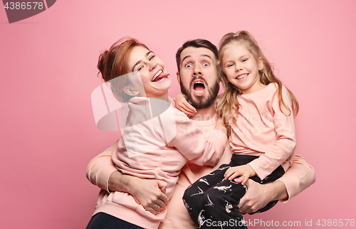 Image of Happy young family with one little daughter posing together