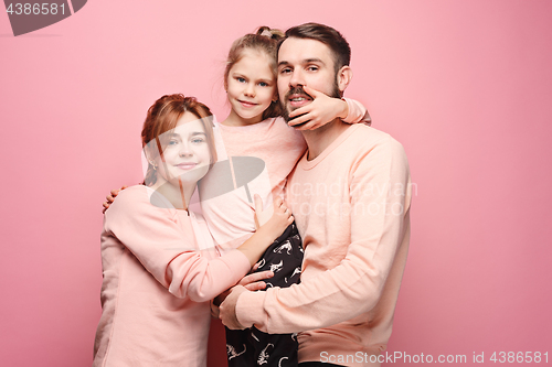 Image of Happy young family with one little daughter posing together