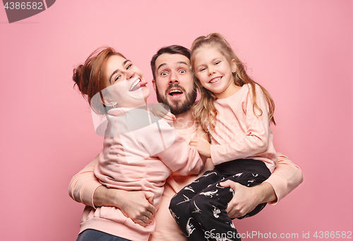 Image of Happy young family with one little daughter posing together