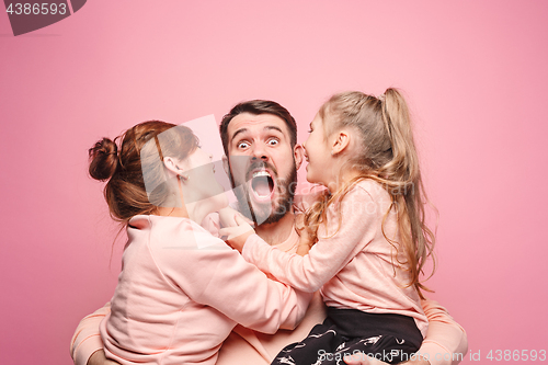 Image of Happy young family with one little daughter posing together