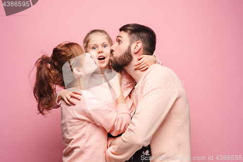 Image of Happy young family with one little daughter posing together