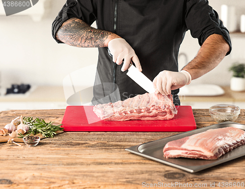 Image of Man cooking meat steak on kitchen