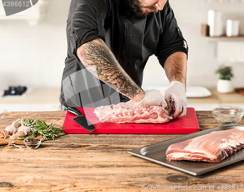 Image of Man cooking meat steak on kitchen