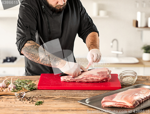 Image of Man cooking meat steak on kitchen