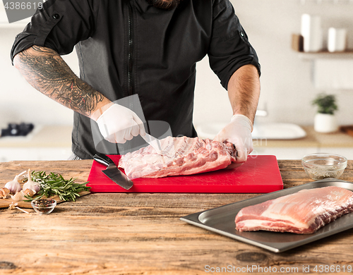 Image of Man cooking meat steak on kitchen