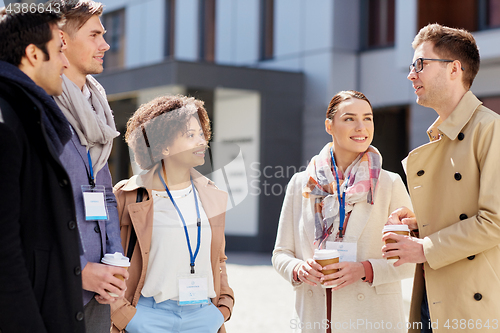 Image of office workers with coffee on city street