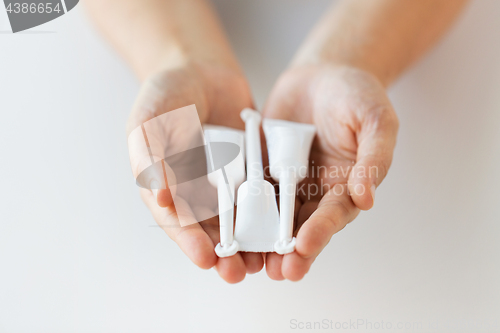 Image of hand holding tubes of micro enema