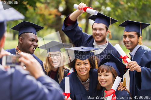 Image of students or graduates with diplomas taking picture