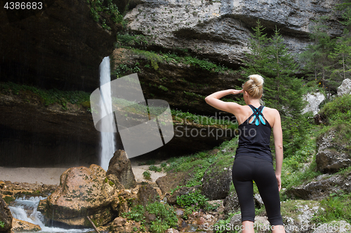 Image of Active sporty woman under a Pericnik waterfall, Slovenia.