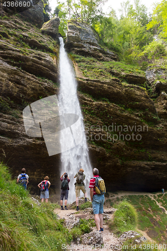 Image of Active tourists looking at Pericnik waterfall in Vrata Valley in Triglav National Park in Julian Alps, Slovenia.