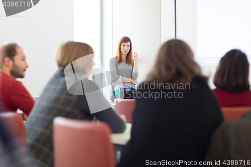 Image of Woman giving presentation in lecture hall at university.