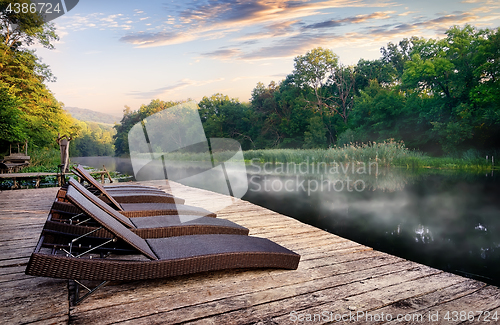 Image of Chaise longues near river