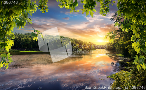 Image of Reflection of sunset in river