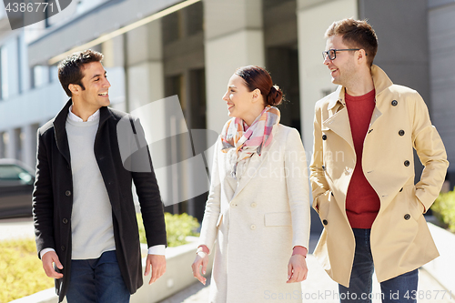 Image of office workers or friends talking on city street