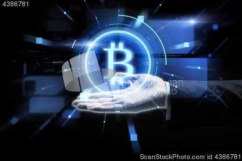 Image of close up of businessman hand with bitcoin symbol