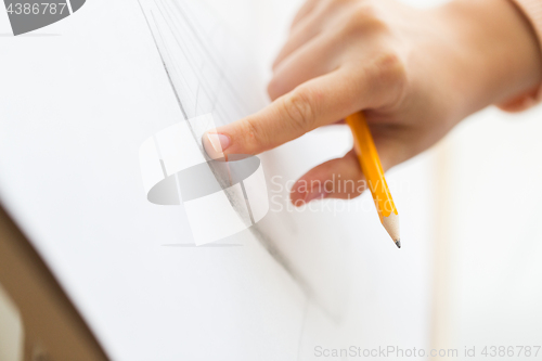 Image of artist with pencil drawing picture at art studio