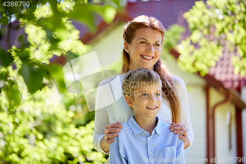 Image of happy mother and son at summer garden