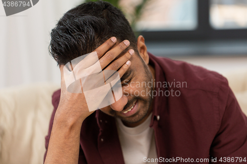 Image of close up of man suffering from head ache at home