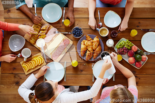 Image of group of people having breakfast at table