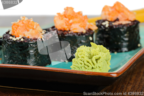 Image of Baked sushi rolls served on turquoise plate