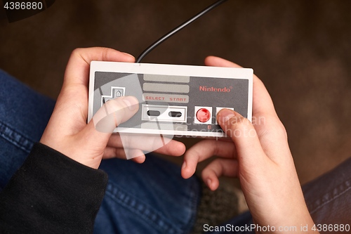 Image of Nintengo NES,playing Super Mario 3