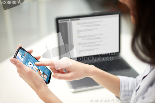 Image of close up of woman with business news on smartphone