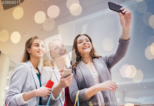 Image of women with smartphones shopping and taking selfie