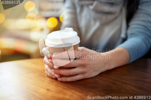 Image of close up of young woman with paper coffee cup